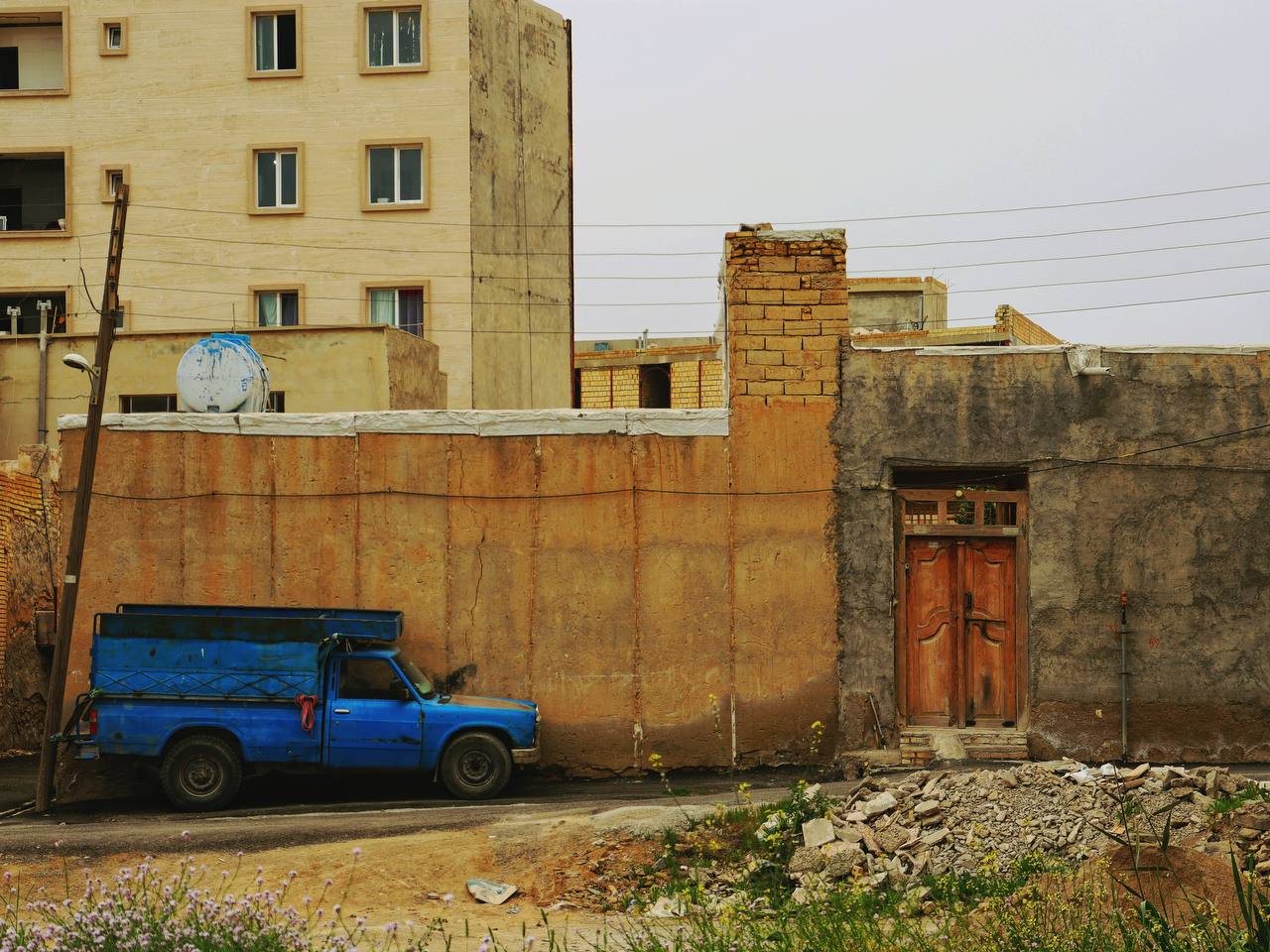 a blue truck parked in front of a building
